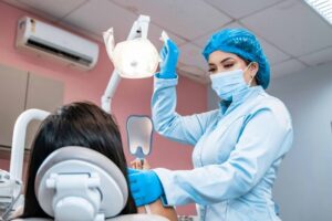 Dentist showing patient mirror after dentures or implants fitting.