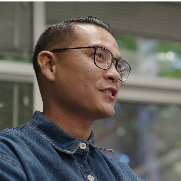 A man in a glasses is smiling