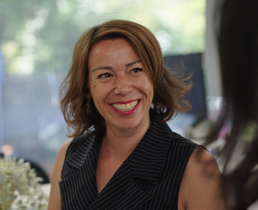 A woman is joyfully smiling at Vallejo Family Dentistry