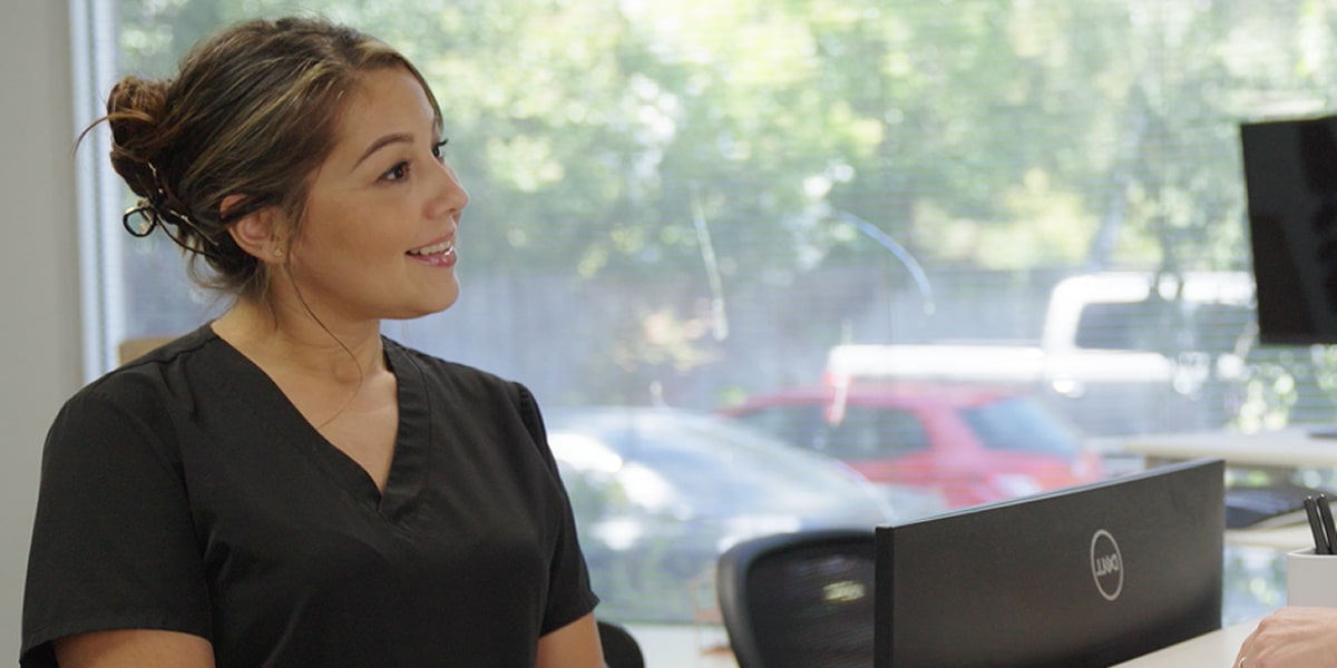 A woman is smiling at Vallejo dentistry