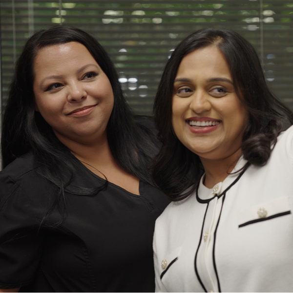 Dental specialist is smiling with her joyful patient