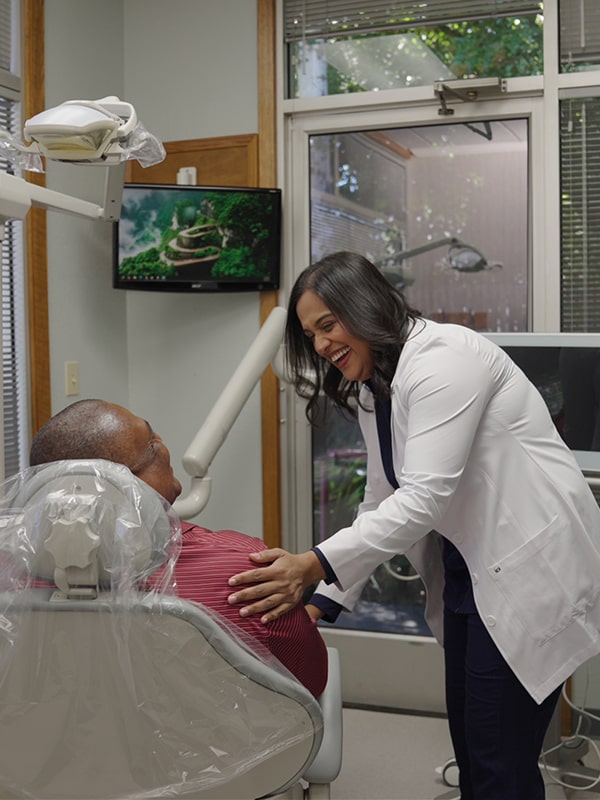 Top Vallejo Family dentist is joyfully smiling with a patient in a chair