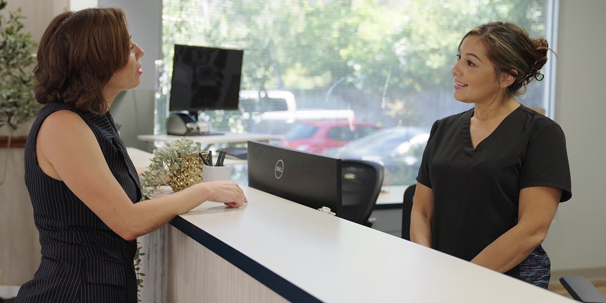 Vallejo Family Dentistry front desk welcoming smiling patient
