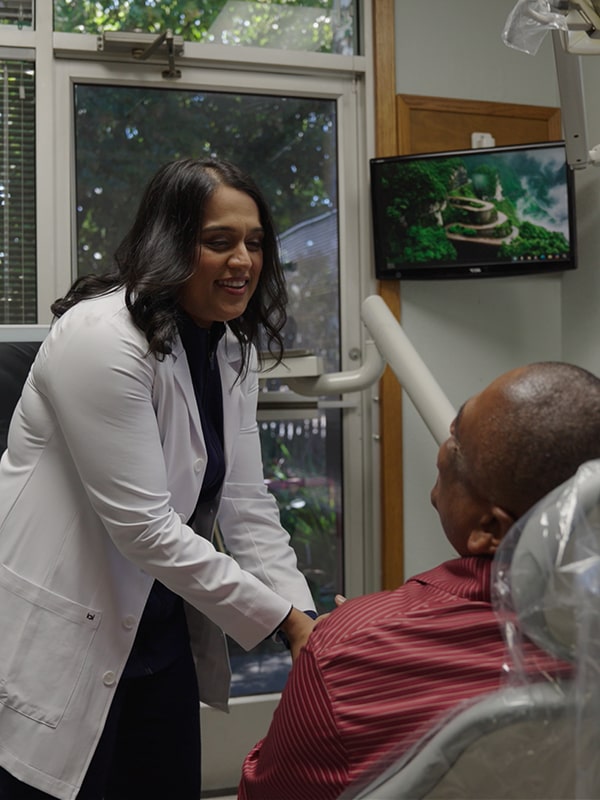 Vallejo dentist is smiling and shaking hands with a patient