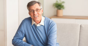 A man in glasses smiling