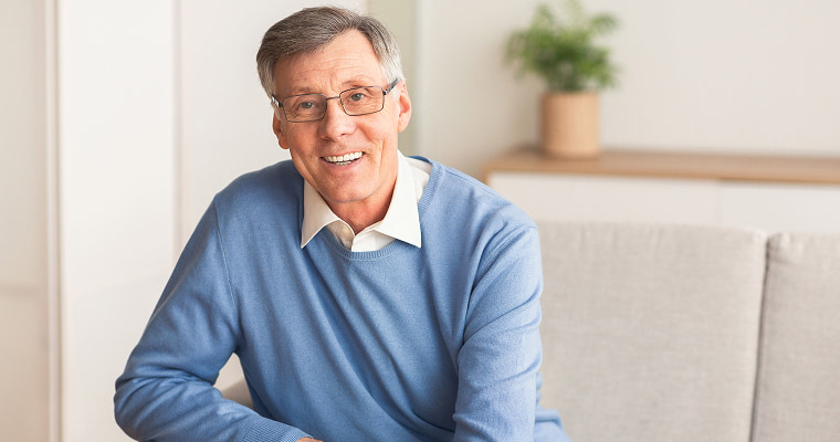 A man in glasses smiling